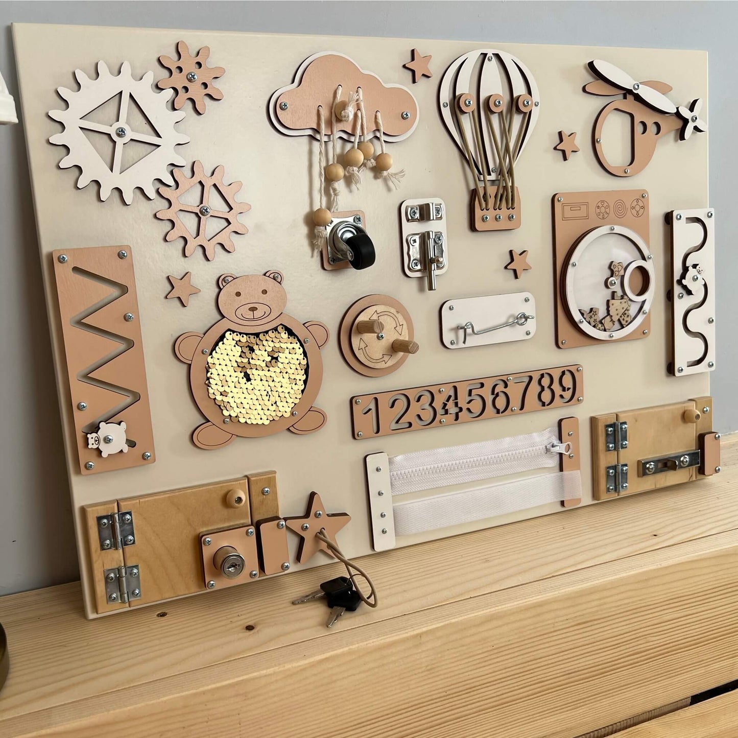 Montessori busy board with doors and locks (40×60 cm)